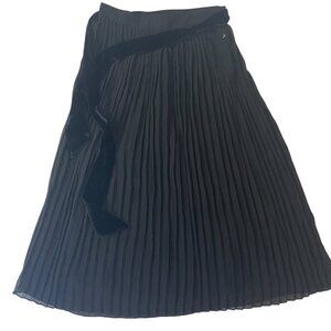 Amelie House. Long black pleated women's dress. Polyester. Made in China.